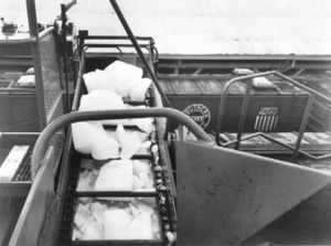 (CC) Photo: Scotty Six The "business end" of a mechanical ice loading system services a line of Pacific Fruit Express refrigerator cars. Each car will require approximately 5½ "short tons" (5 metric tons) of ice.