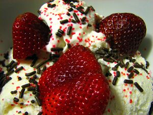 Dessert made of vanilla ice cream, fresh strawberries, chocolate décors and red crystal sprinkles.jpg
